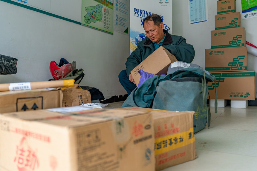 張林昌在整理即將派送的包裹。人民網 涂敏攝
