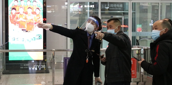 工作人員在給乘客指路。