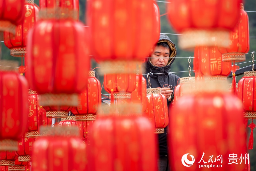 為迎接春節(jié)，翁井村村民正在掛紅燈籠。人民網(wǎng) 涂敏攝