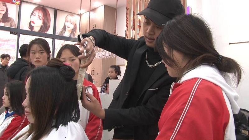 3月24日,畢節(jié)同心職校學(xué)生在大方縣佳鑫廣場(chǎng)實(shí)訓(xùn)基地觀看學(xué)習(xí)發(fā)老師美發(fā)過程。(萬瑩芳 攝).jpg