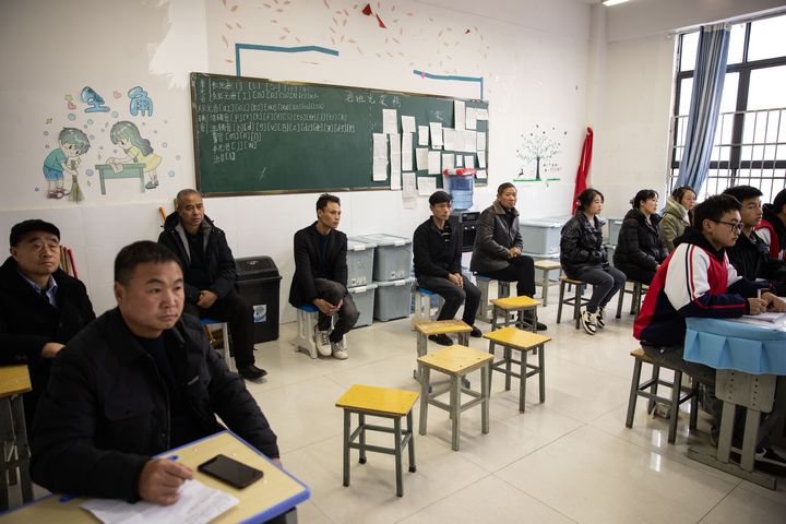 家長走進(jìn)開放課堂，與孩子們一起聆聽老師講課。謝永奇攝