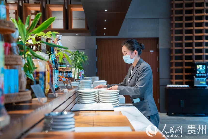 餐飲服務(wù)人員認(rèn)真擺放餐具。人民網(wǎng) 陽茜攝