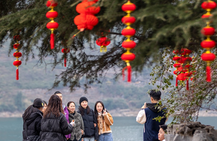 游客在碼頭廣場拍照。