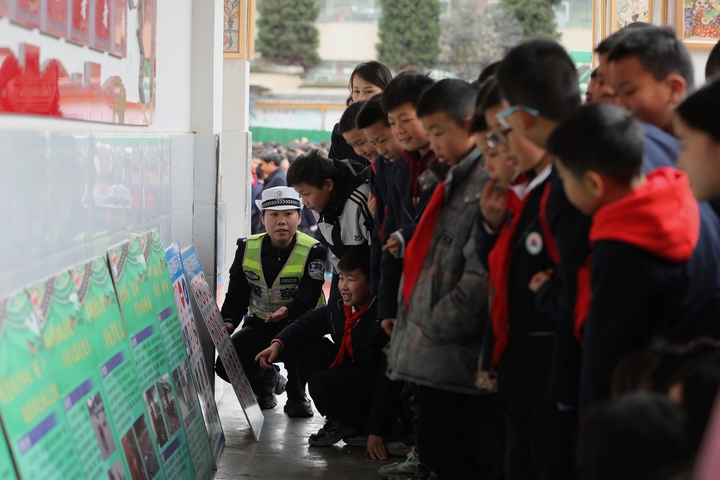 圖為：2025年2月17日，雷山縣公安局交警大隊輔警向學生講解宣傳展板1.JPG