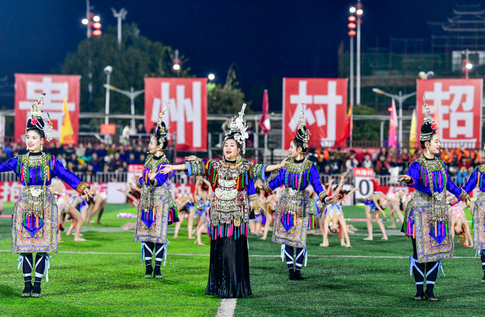 2025年3月14日,2025年貴州“村超”40強交叉賽在榕江“村超”足球場舉行,演員在比賽間隙表演侗族大歌,民族文化伴隨著體育賽事成功“出圈”。圖片來源:新華社