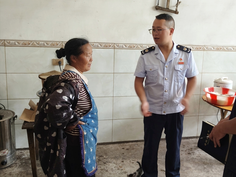 稅務(wù)干部徐偉走訪少仲村村民，了解危房改造后村民情況。陳友元攝