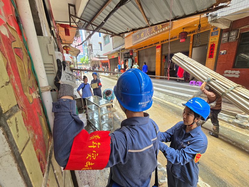 在黔東南苗族侗族自治州榕江縣，南方電網公司搶修人員給商鋪更換新的電表。謝釋與攝