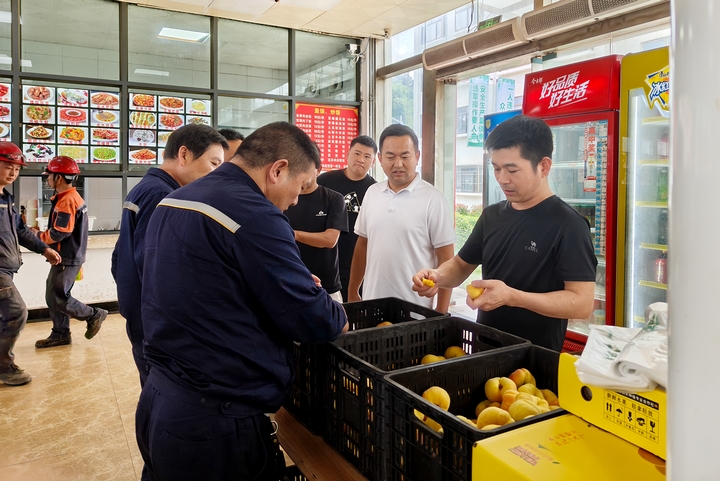 貴州華錦鋁業公司食堂內職工購買新鮮的蟠桃。伍明莉攝