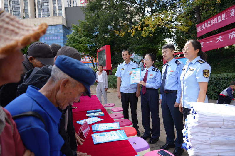 圖為稅務干部為參加活動的人員答疑解惑。李琪攝