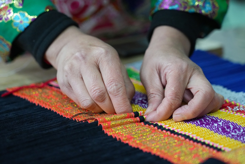 2026年1月5日,貴州省畢節市納雍縣豬場鄉富納蠟染刺繡農民專業合作社,繡娘在縫制裙褶。 楊英攝