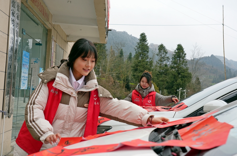 2026年1月26日，貴州省畢節市納雍縣張家灣鎮普灑社區，大學生志愿者在整理春聯。
