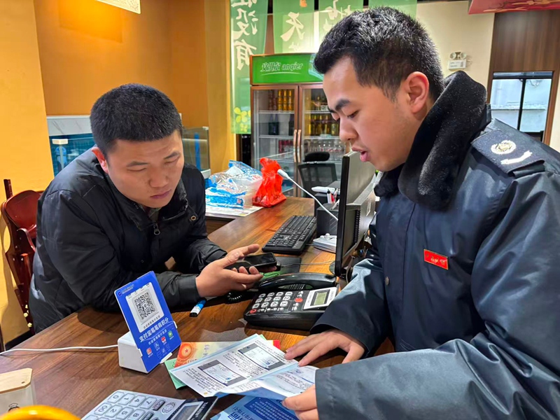 圖為稅務(wù)干部龍燈會(huì)前到丁肥子餐館進(jìn)行宣傳輔導(dǎo) 。王秋華 攝
